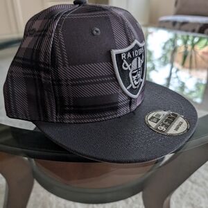 New Era Black and Gray Raiders Plaid Snapback Hat